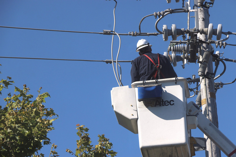 PG&E repairman works on powerline after outage
