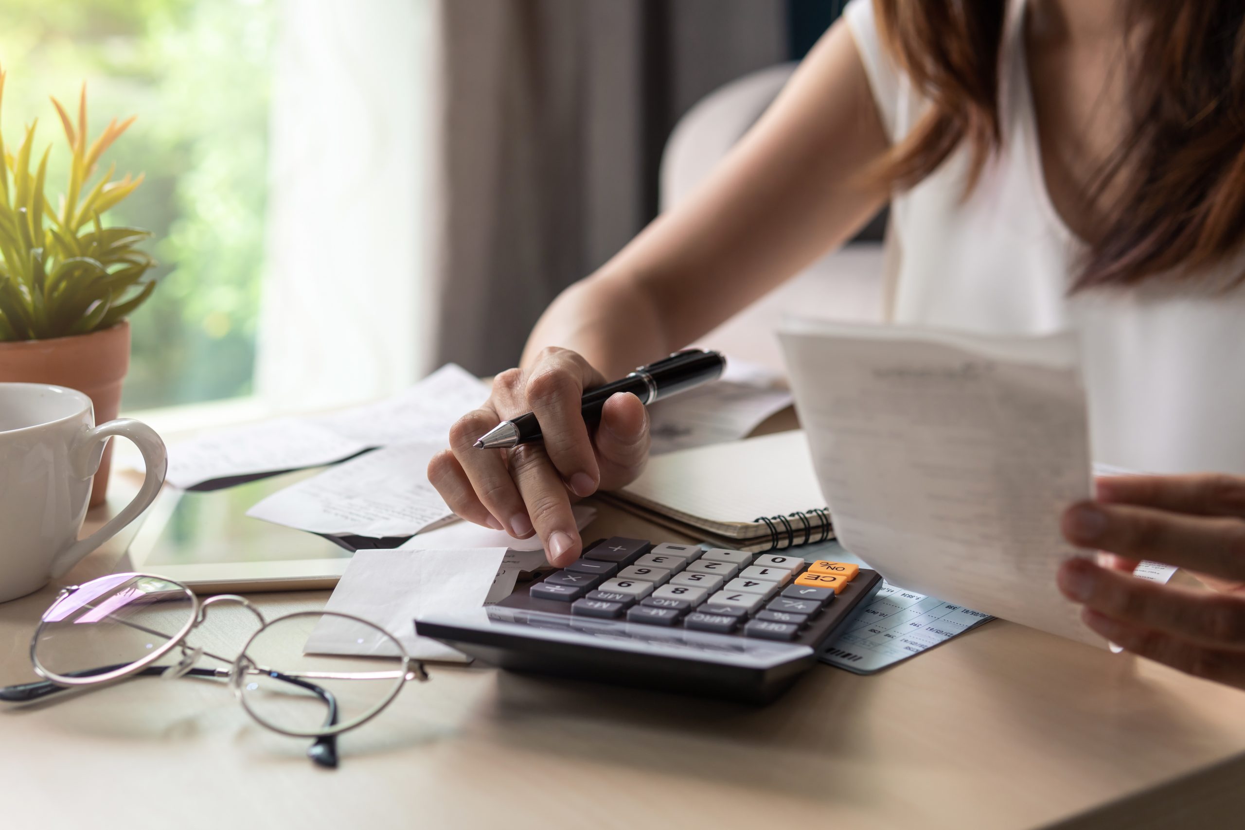 young woman calculating number of solar panels needed for her home